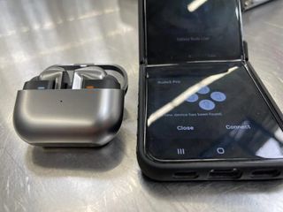 Samsung Galaxy Buds 3 Pro charging case next to Samsung Galaxy Z Flip 4