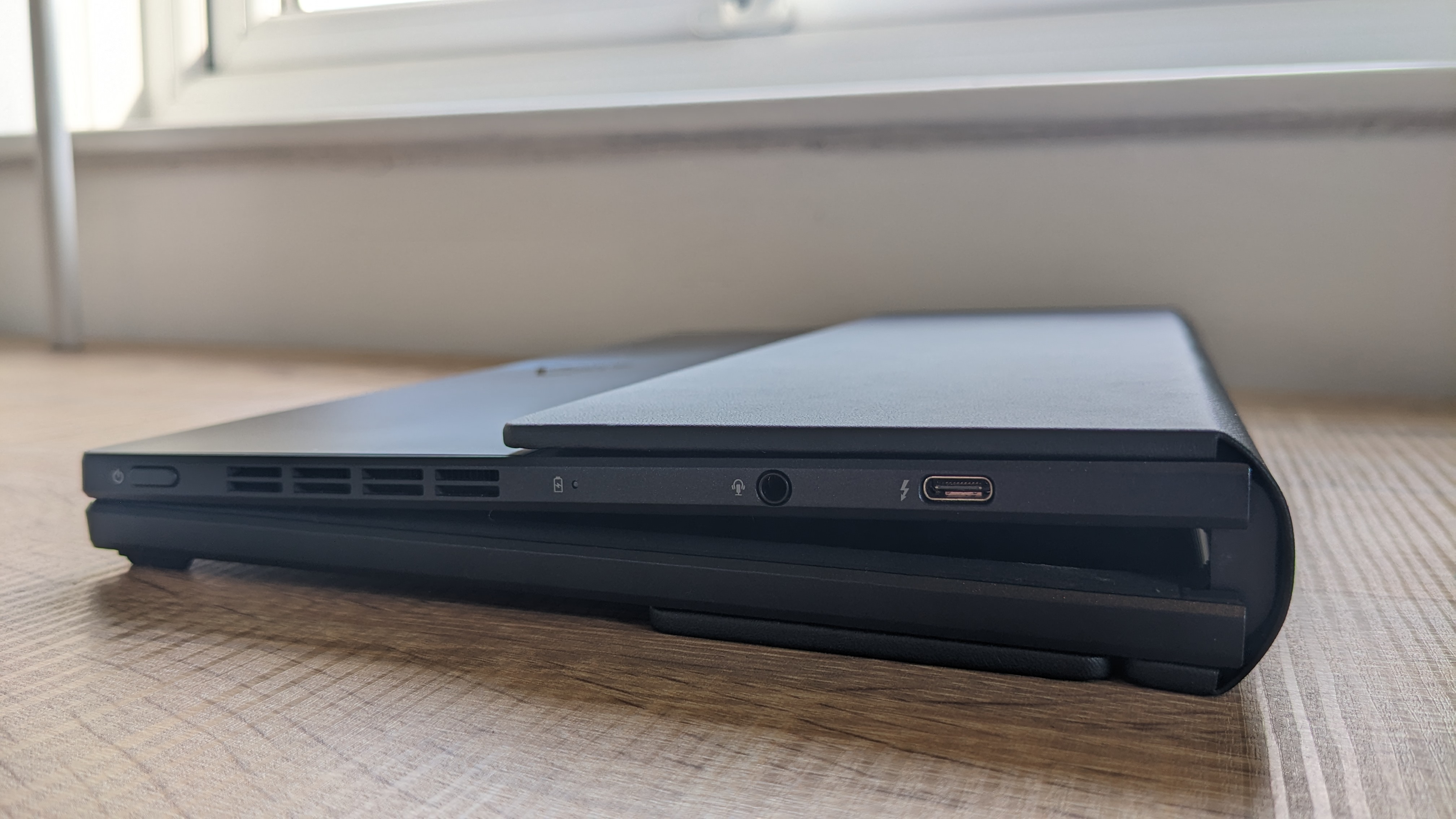 The Asus Zenbook 17 Fold OLED pictured on a wooden desk.