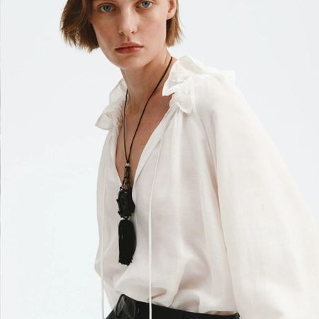 Woman wears white blouse