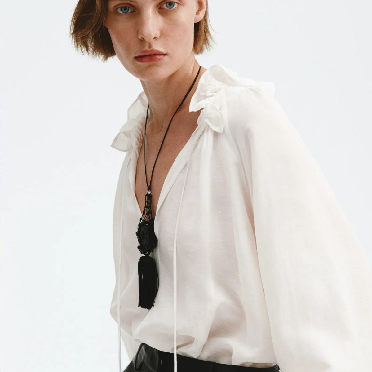 Woman wears white blouse