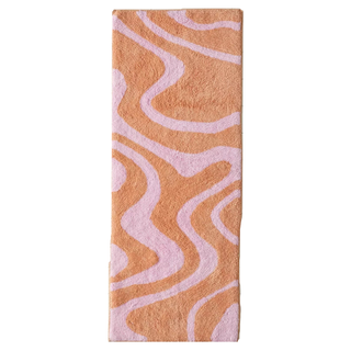 A pink and orange marbled runner bath mat