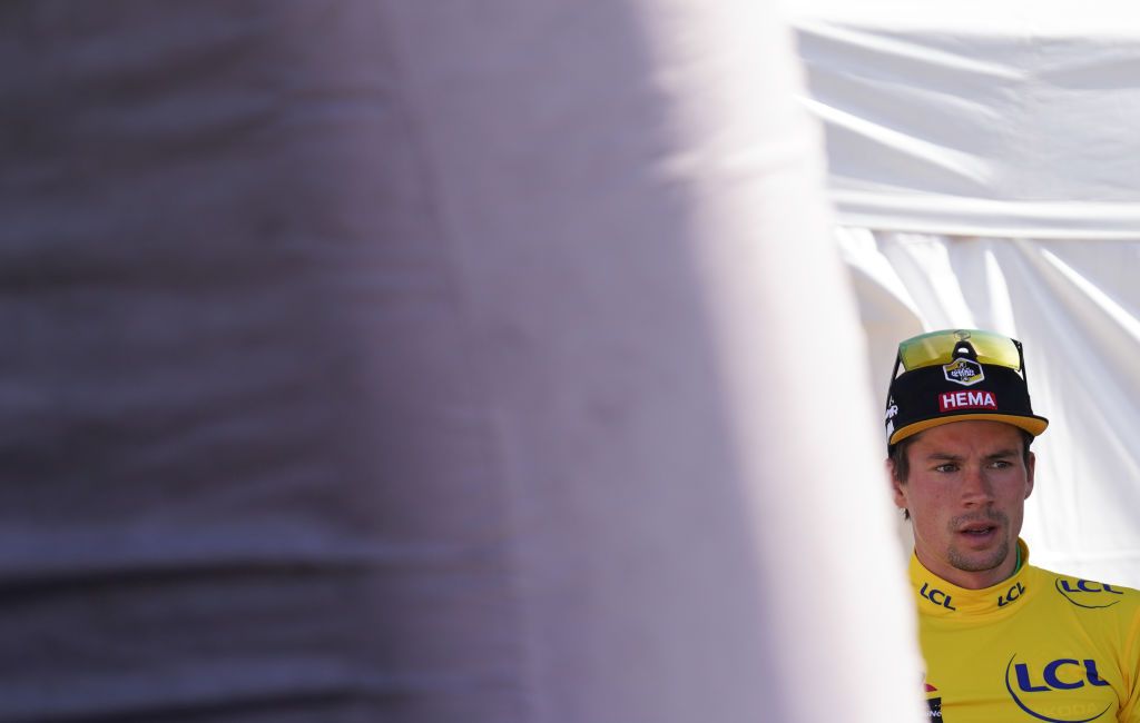 Team Jumbo rider Slovenias Primoz Roglic wearing the overall leaders yellow jersey leaves the podium after the fourth stage of the 72nd edition of the Criterium du Dauphine cycling race 153 km between Ugine and Megeve on August 15 2020 Photo by EDDY LEMAISTRE AFP Photo by EDDY LEMAISTREAFP via Getty Images