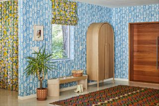 Hallway with concrete floor and blue patterned wallpaper