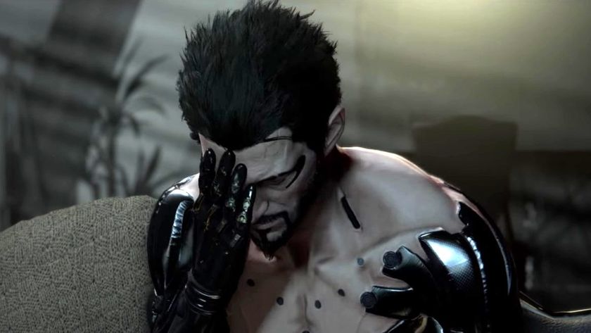 Adam Jensen with his head in his hands.