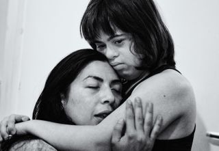 Two women, one with down syndrome, hug