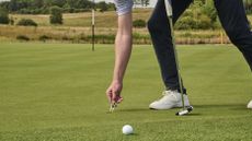 Repairing a pitch mark on the green