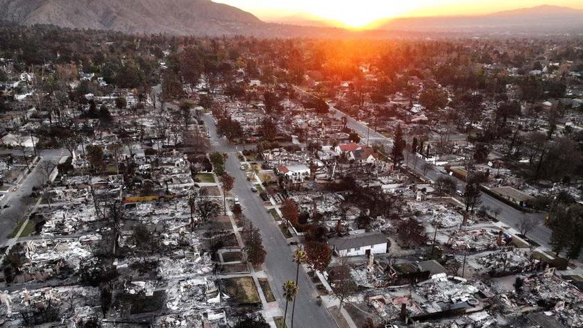 An aerial view of the sun rising above homes that burned in the Eaton Fire on Jan. 21 in Altadena, Calif.