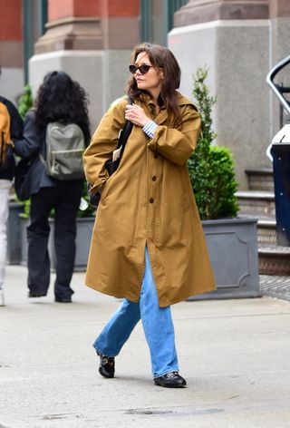 Katie Holmes walking in New York City April 2024 wearing her easy outfit formula of a khaki coat and jeans