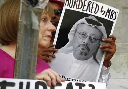 People hold signs during a protest at the Embassy of Saudi Arabia about the disappearance of Saudi journalist Jamal Khashoggi, Wednesday, Oct. 10, 2018, in Washington.