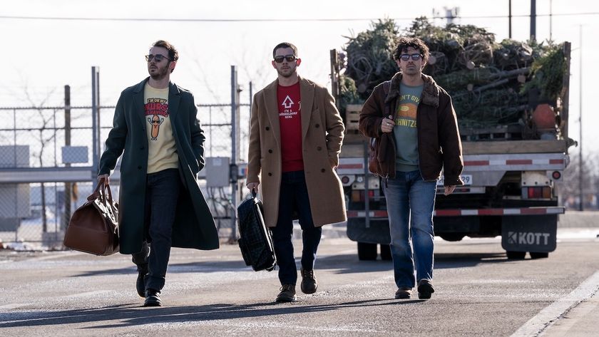 Kevin Jonas, Nick Jonas and Joe Jonas walking together with their bags in A Very Jonas Christmas Movie 