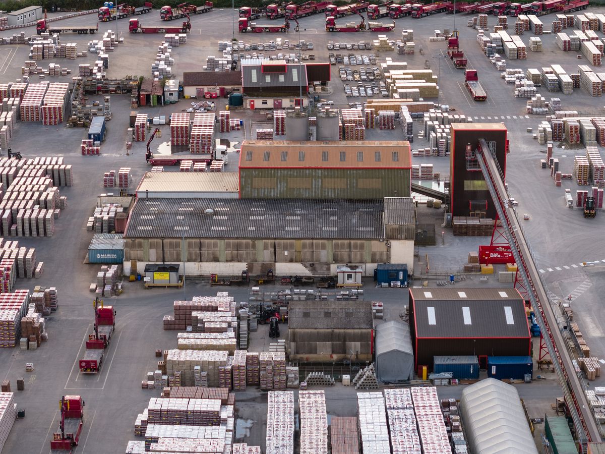 Image taken by DJI Air 3 (a camera drone). Here we see an overhead view of a shipping yard full of shipping containers.