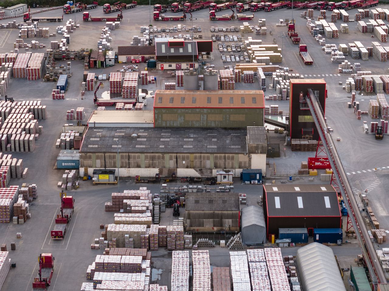 Image taken by DJI Air 3 (a camera drone). Here we see an overhead view of a shipping yard full of shipping containers.