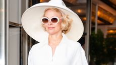 Pamela Anderson in a white hat and sunglasses
