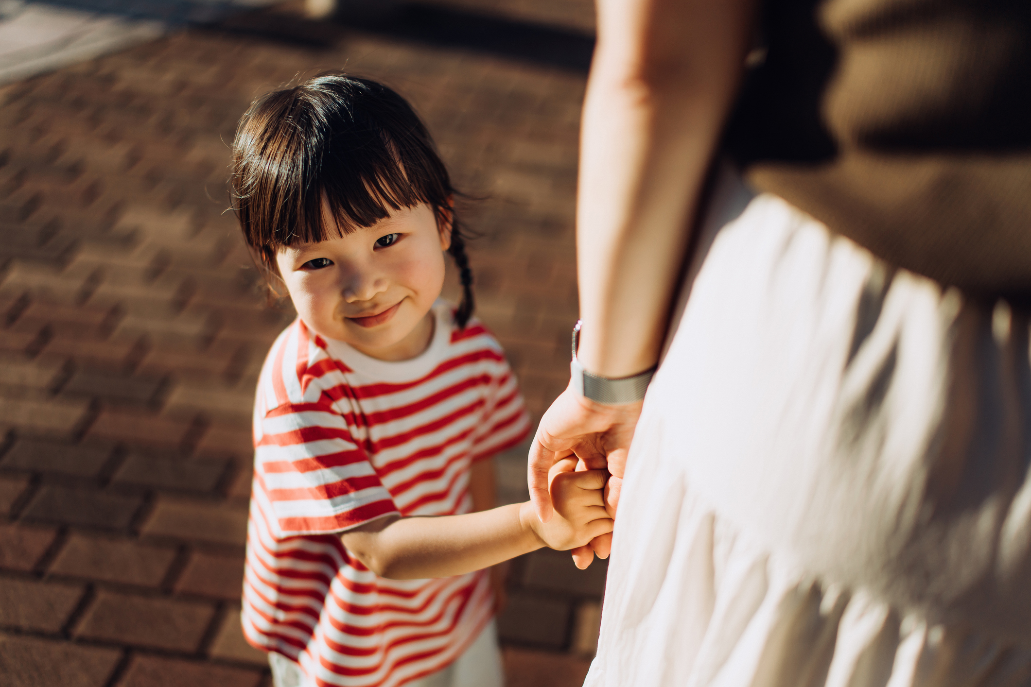 Mother and child holding hands
