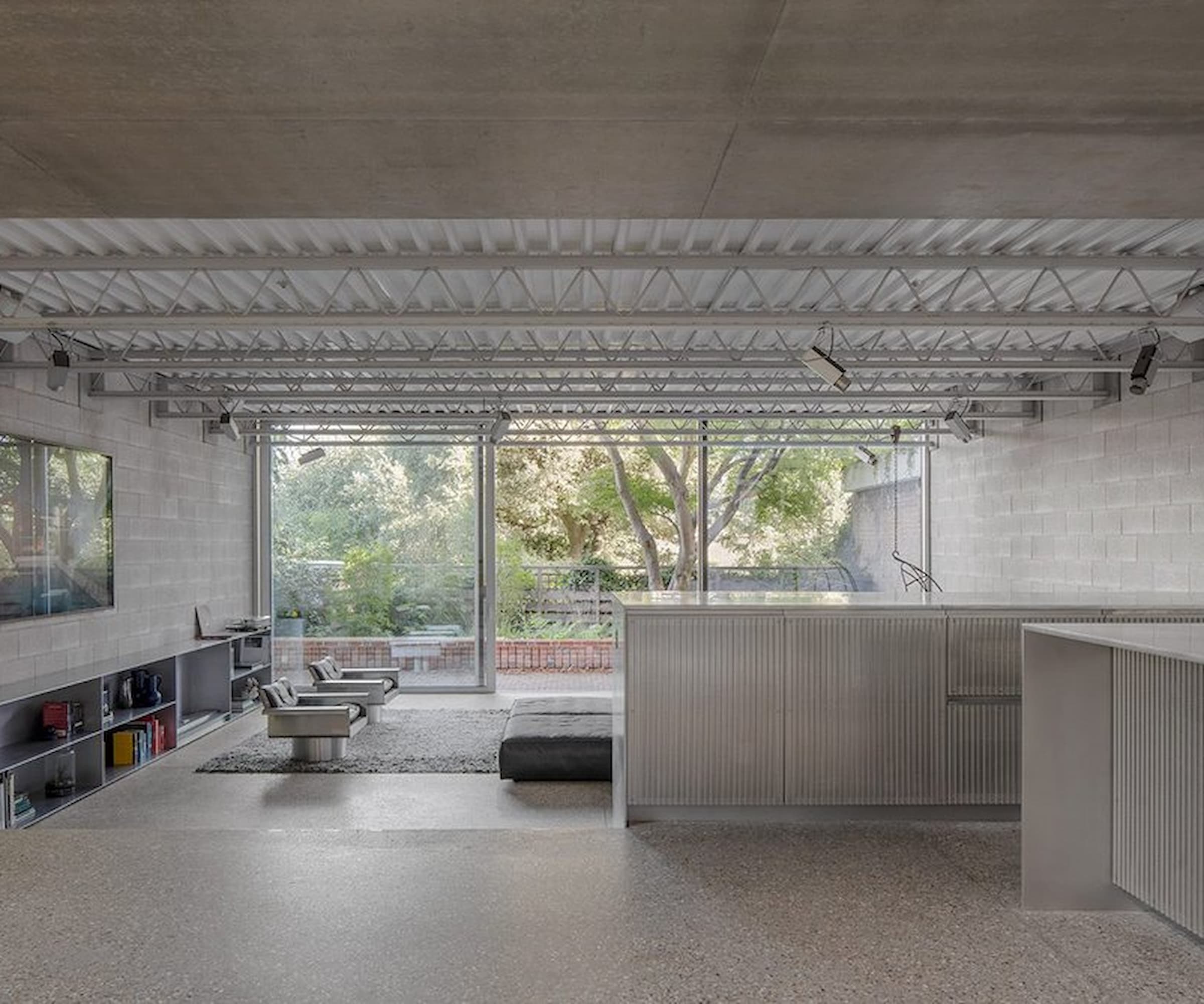 A bottom floor, open plan living room with a tv on the wall