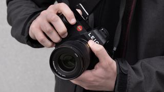 Two hands holding the Leica SL3 camera