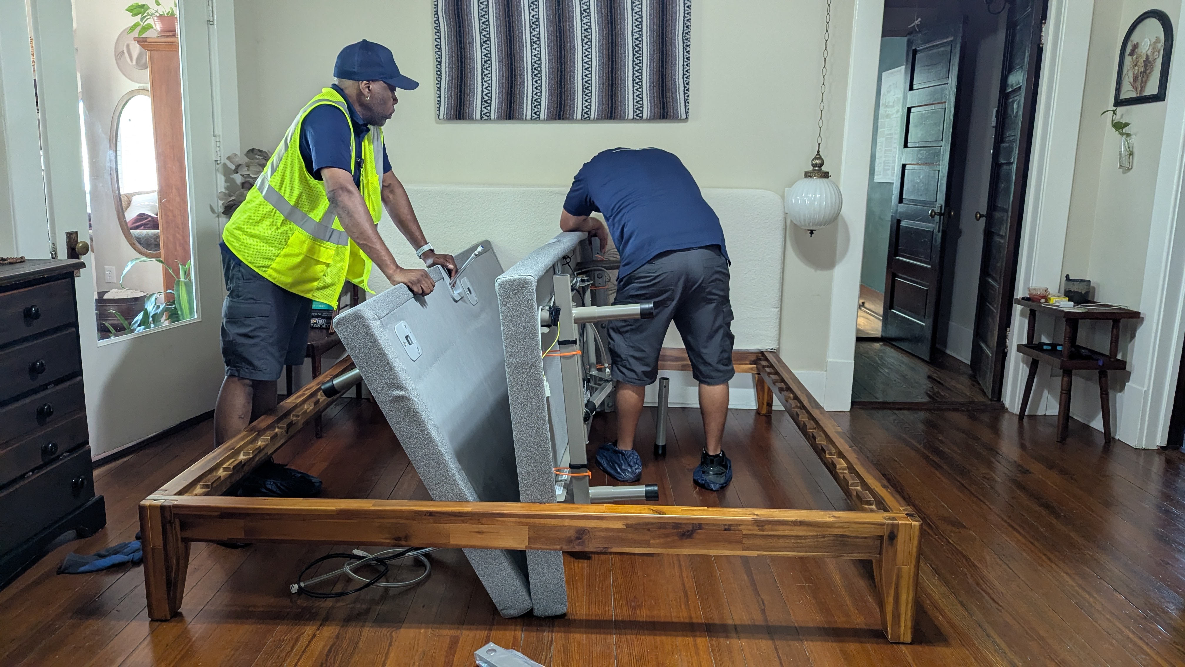 Delivery men installing Sleep Number i8 smart mattress
