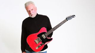 Pete Anderson poses with a Reverend signature guitar