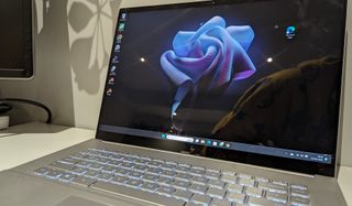 A silver HP Envy 16 laptop sitting on a table