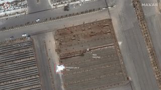 An image from Maxar's WorldView-3 satellite shows the Behesht-e Masoumeh cemetery in Qom, Iran, on March 1, 2020. The cemetery is preparing for the pandemic by digging two long "trenches" of graves, each about 100 yards (90 meters) long. 