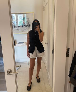 @nicoleakhtarzad summer vest and shorts outfit mirror selfie.