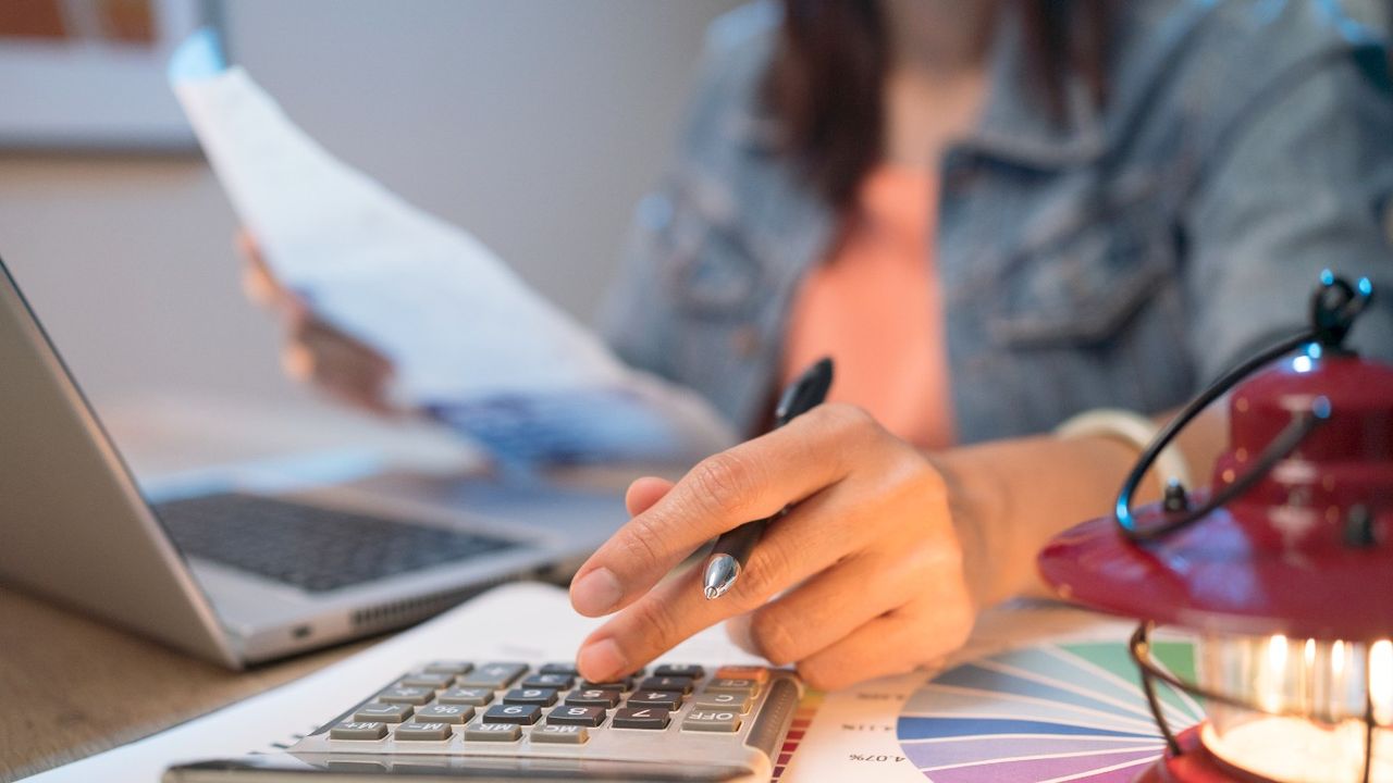 Person working out budget on a calculator