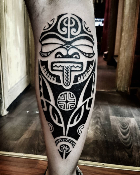 Tribal mask-inspired tattoo