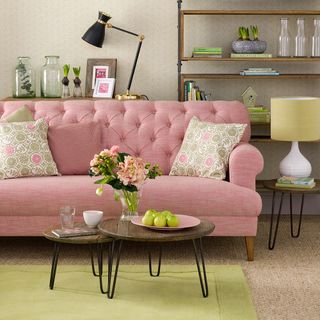 living room with coffee table and pink sofa
