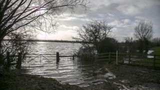 BRIDGWATER, UNITED KINGDOM - JANUARY 28:A gate leads into a flooded field at Burrow Bridge on January 28, 2014 in Somerset, England. As Lord Smith, the chairman of the Environment Agency, adm