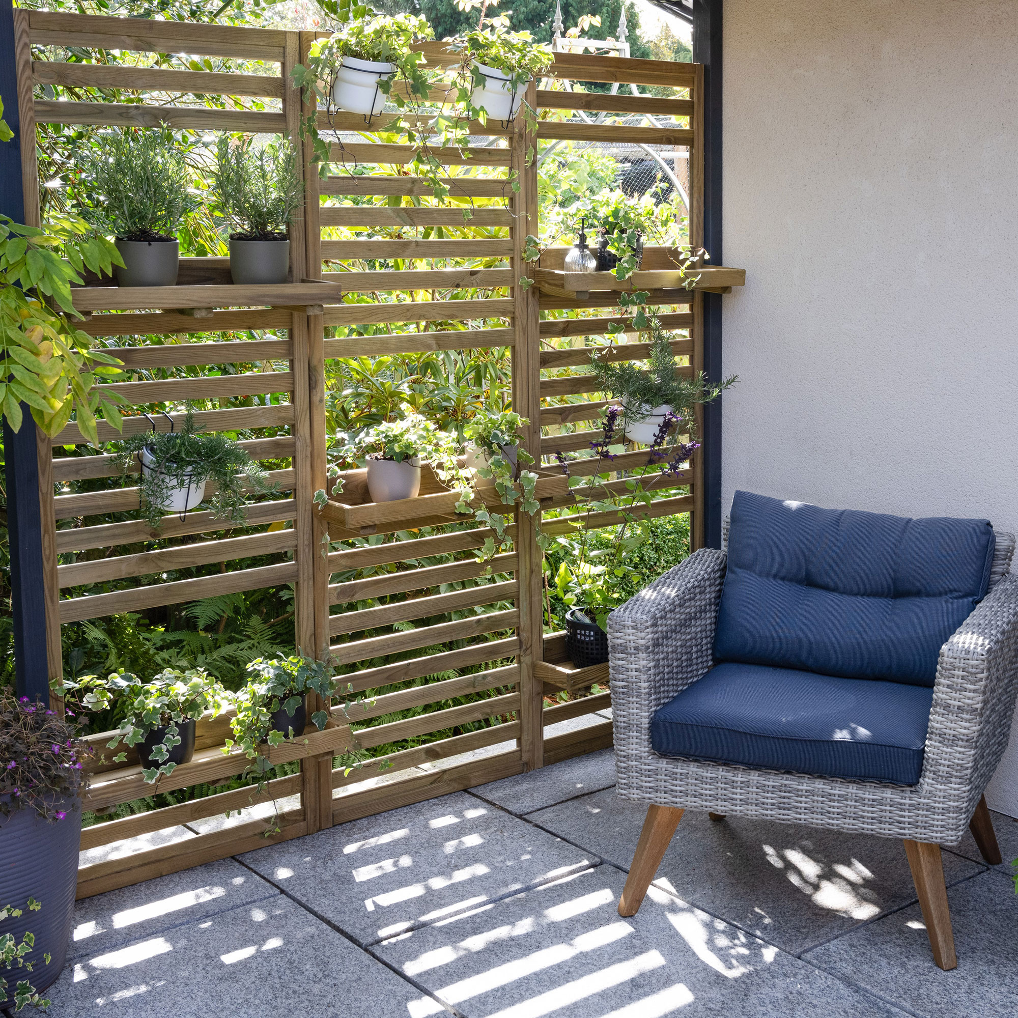 Slatted fencing with shelving attached on patio