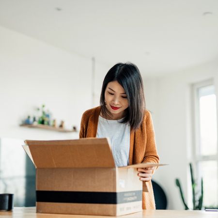 woman opening a package 