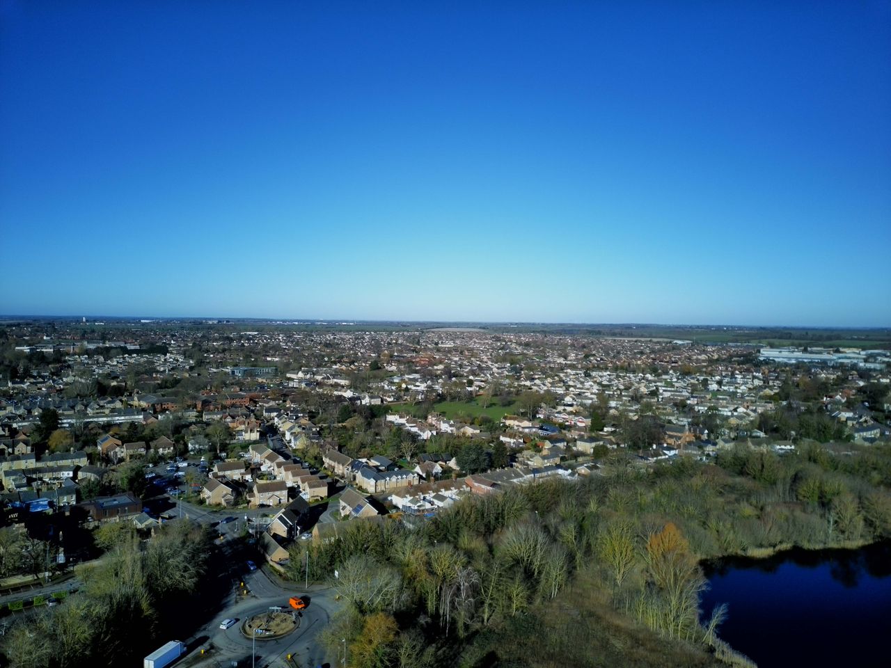 Aerial shot of a English town surrounded by trees