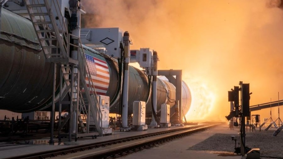 a rocket engine from the left spews blinding fire to the right