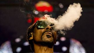 Snoop Dogg smoking on stage