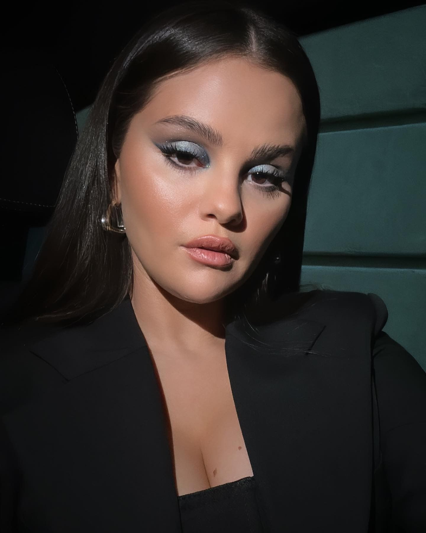 Selena Gomez taking a selfie with laminated, or "soap" brows.