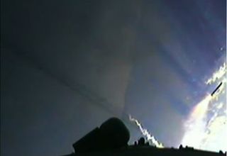 This view from an Ariane 5 rocket camera shows the rocket's boosters (one at far right) falling away after being jettisoned during a successful launch of the European ATV-3 cargo ship toward the International Space Station on March 23, 2012.