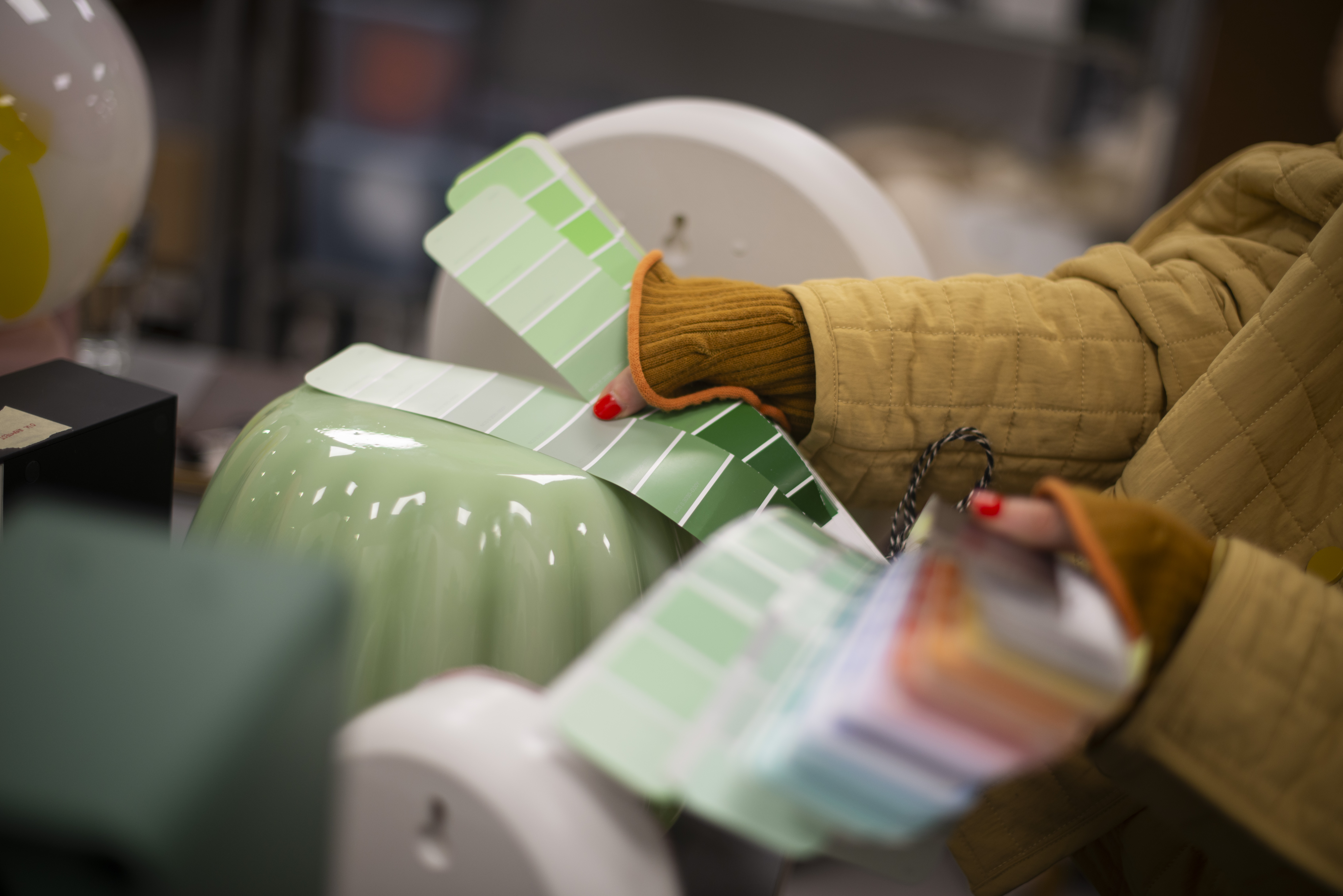 colour swatches held next to a mint green glass lamp shade