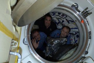 The Expedition 36 crew of the International Space Station waves farewell before undocking a Soyuz space capsule to return to Earth on Sept. 10, 2013. They are Russian cosmonauts Alexander Misurkin (right), Pavel Vinogradov (left) and NASA astronaut Chris Cassidy.
