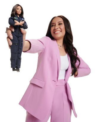 Katya Echazarreta holds out the Barbie doll created in her likeness after being honored as a STEM role model.