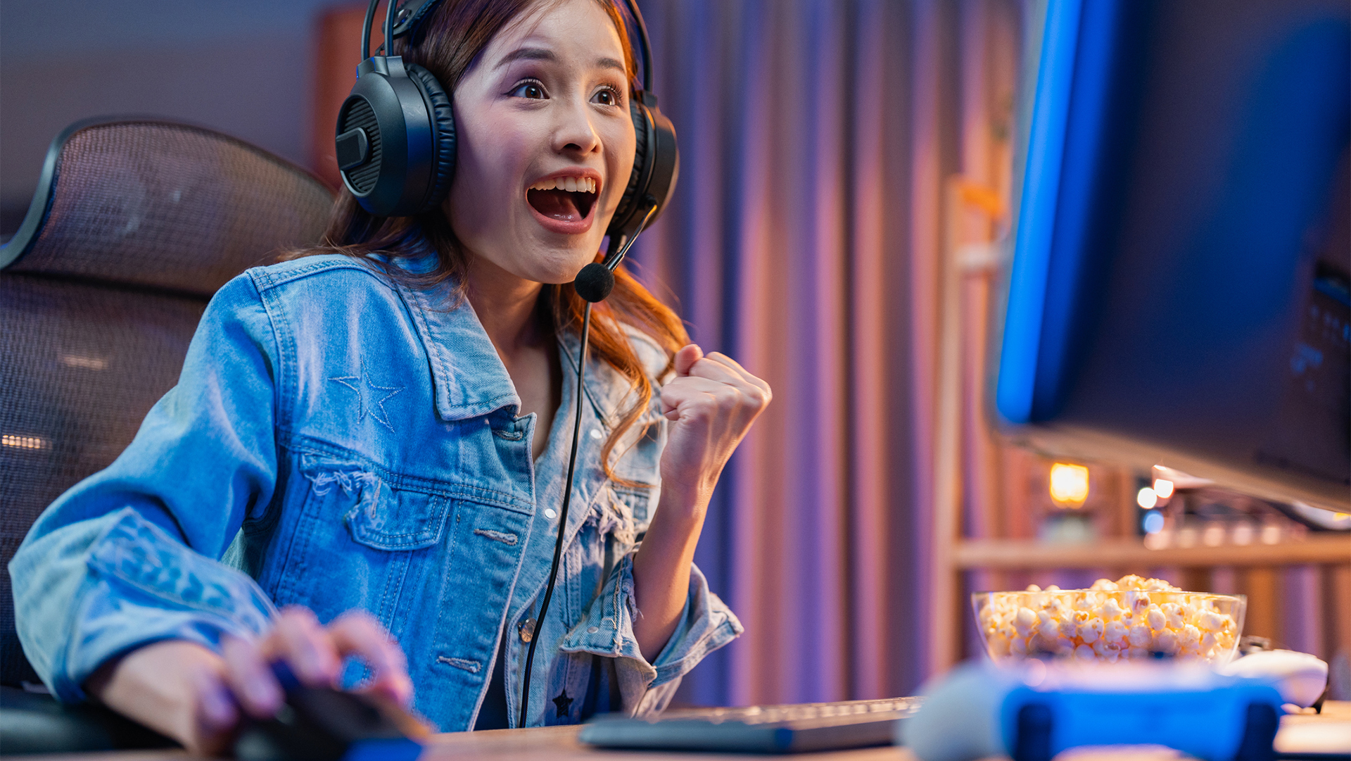 A teenage girl feels delighted after winning a computer game.