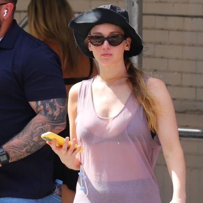 Jennifer Lawrence brings back the controversial dress-over-pants trend.