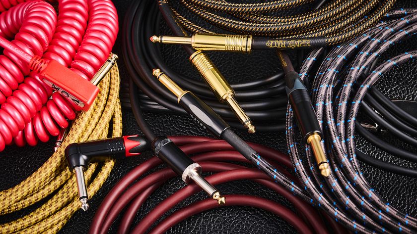 Collection of guitar cables coiled on top of an amp
