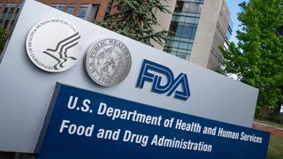 photo shows a large sign outside of a multistory brick and cement building that reads: FDA: U.S. Department of Health and Human Services, Food and Drug Administration 