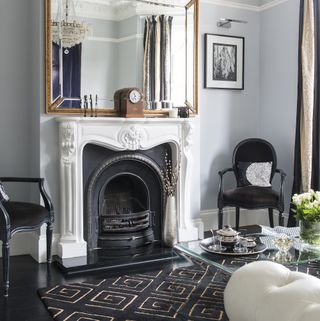 pale grey living room with black and gold accessories
