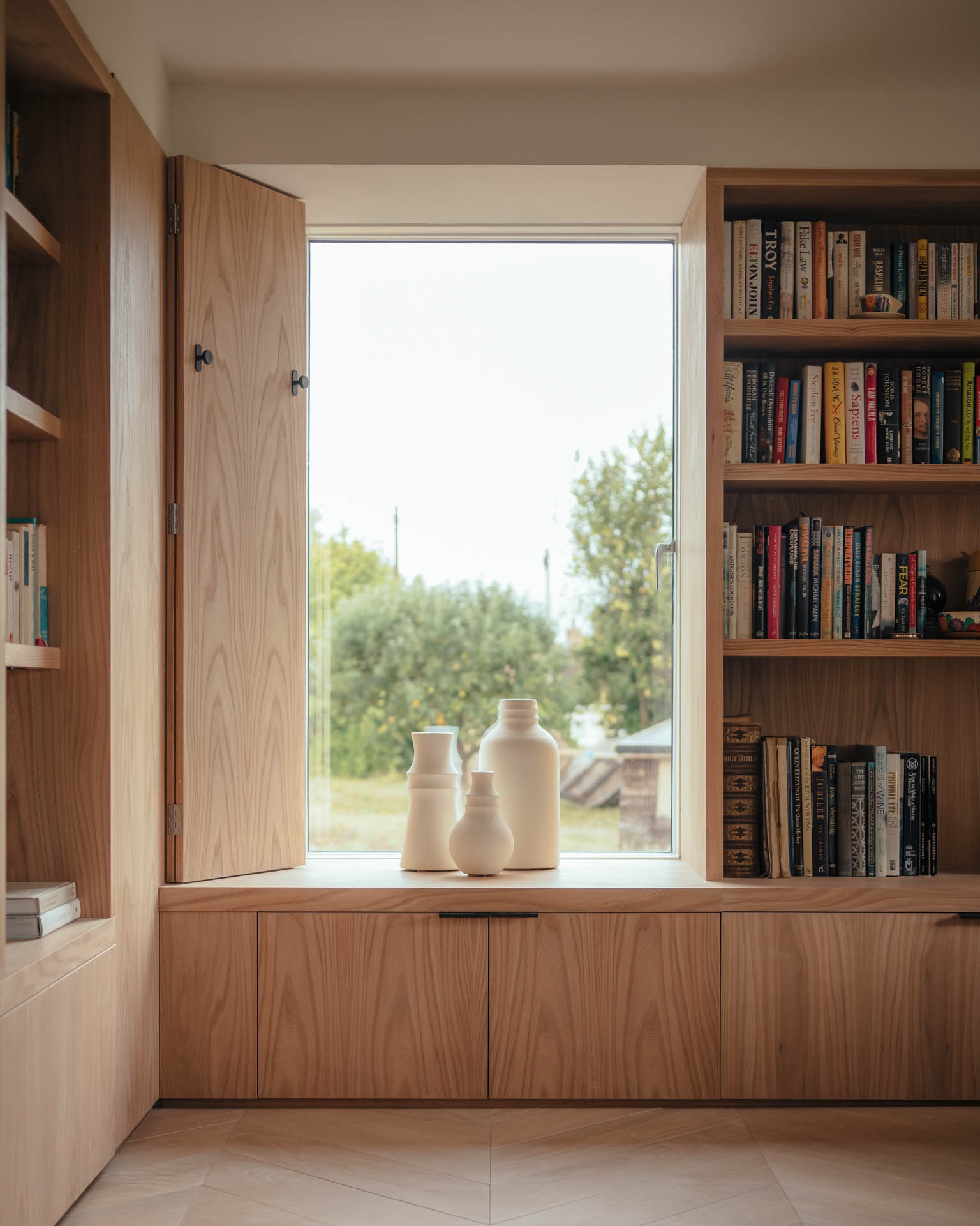 modern country house with pale timber joinery, built-in storage, large picture windows and modern shutters