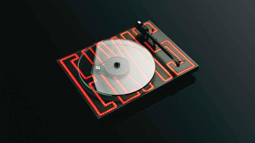 The Pro-Ject Elvis Turntable (with &#039;Elvis&#039; spelled out in red LED lighting on the plinth) on a black background.