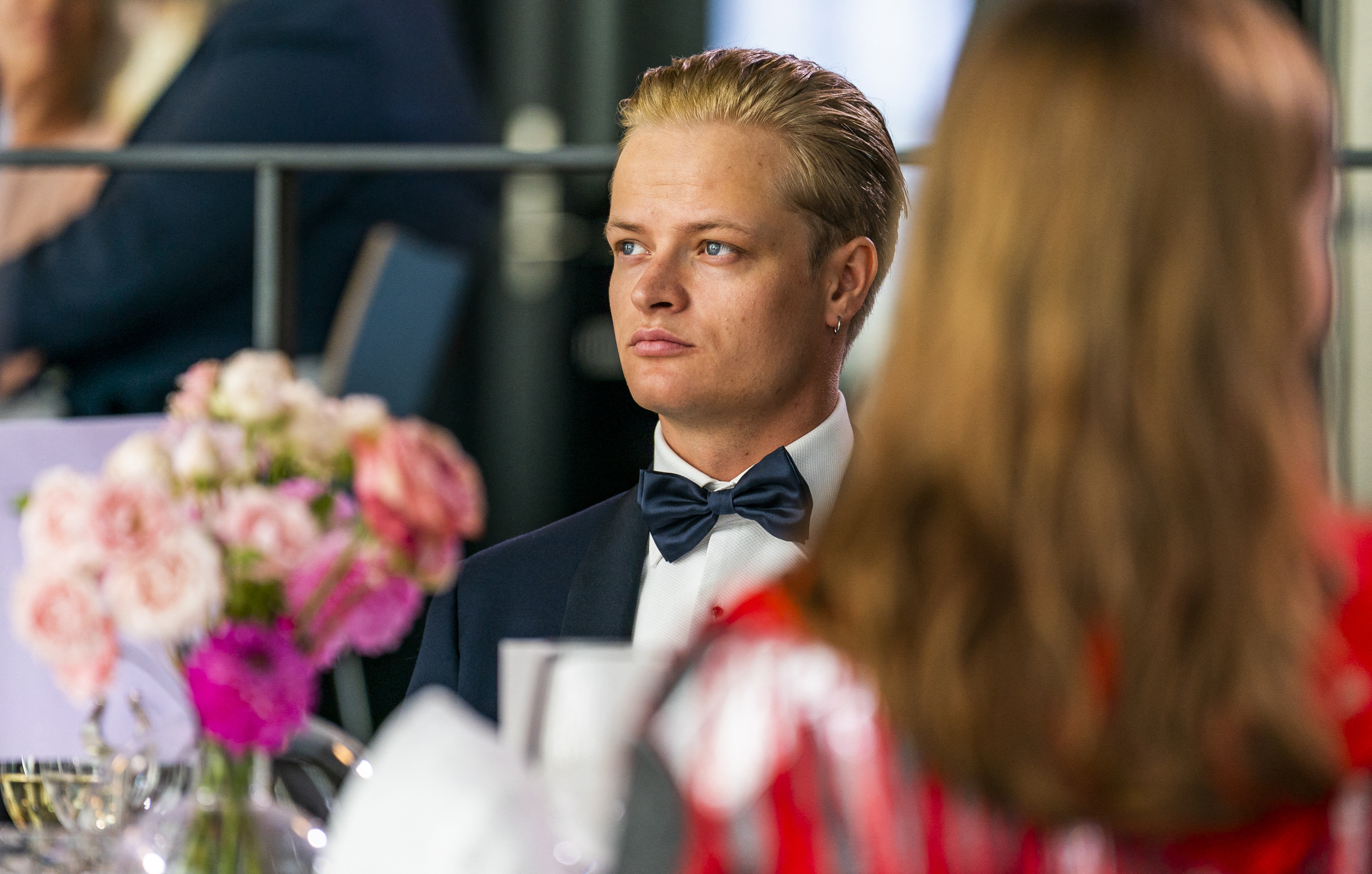 Marius Borg Hoiby wearing a black tuxedo sitting at a dinner table