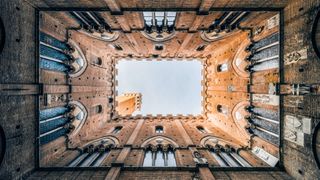 Skyward shot through medieval courtyard building