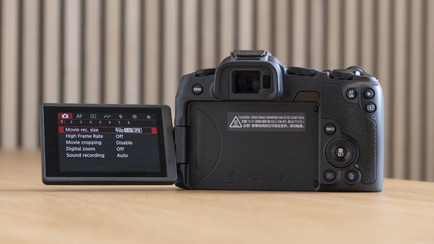 Canon EOS R8 on a table rear view with vari-angle screen flipped out to the side