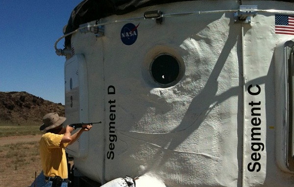 An air rifle is used to test the NASA Habitat Demonstration Unit.